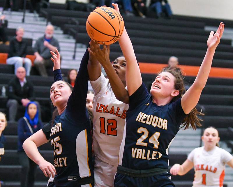 DeKalb's Brytasia Long (12) battles for a loose ball along with Neuqua Valley's Vlera Maliqi (25) and teammate Nalia Clifford (24) during the game on Thursday Feb. 6, 2025, held at DeKalb High School.