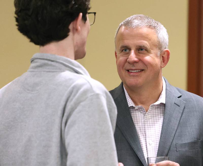 DeKalb Mayor Cohen Barnes talks to an attendee Tuesday, April 1, 2025, during his election night party at Faranda's Banquets in DeKalb.