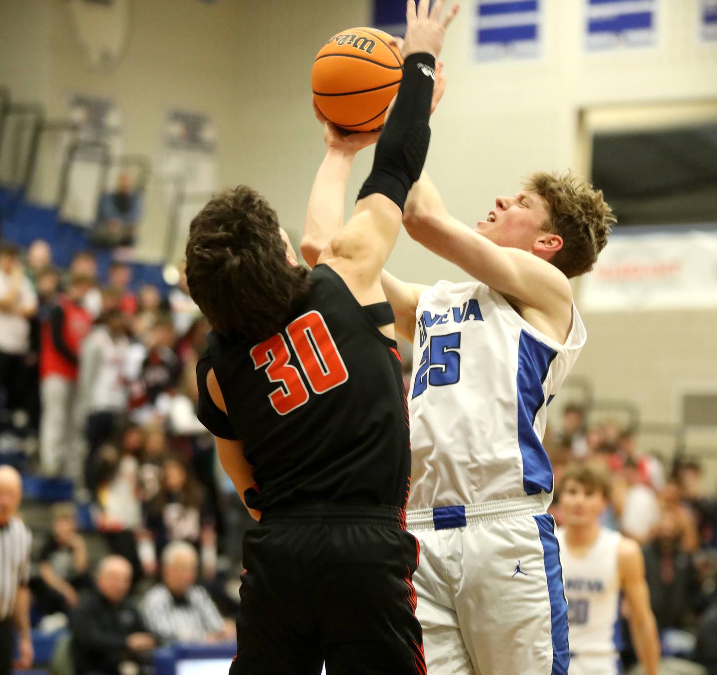 Geneva’s Hudson Kirby (right) attemps a shot over Wheaton Warrenville South’s Luca Carbonaro during a game on Friday, Jan. 24, 2025 at Geneva.