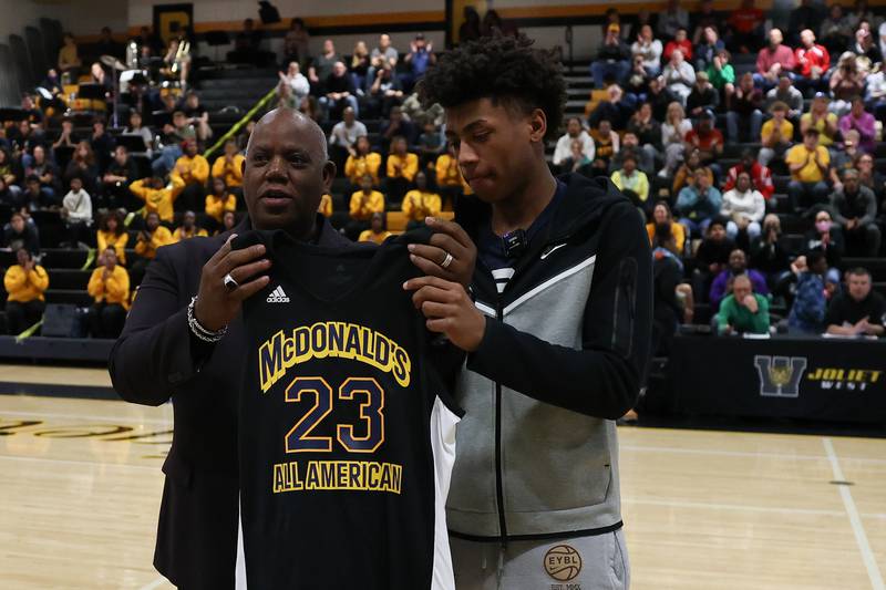 Derrick Lott (left), of the Joliet Black McDonald’s Operators Association, presents Joliet West’s Jeremy Fears with his McDonald's All-American jersey. The game featuring the top high school players in the nation will be played March 28.