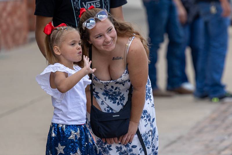(from left) Novalyn Carter waves at parade procession with Paige Persic on Sunday, Aug 31, 2025 at the Labor Day parade on Main Street in Streator.