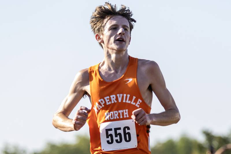 Naperville North’s Jackson Truty crosses the finish line during the Locktoberfest three-mile varsity cross country race at Dellwood Park in Lockport on October. 4, 2025.