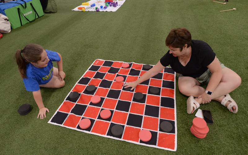 (left) Laura Coyle of Glen Ellyn and her mom Merry play checkers during the Glen Ellyn Park District unplug from technology event held Saturday July 13, 2024.