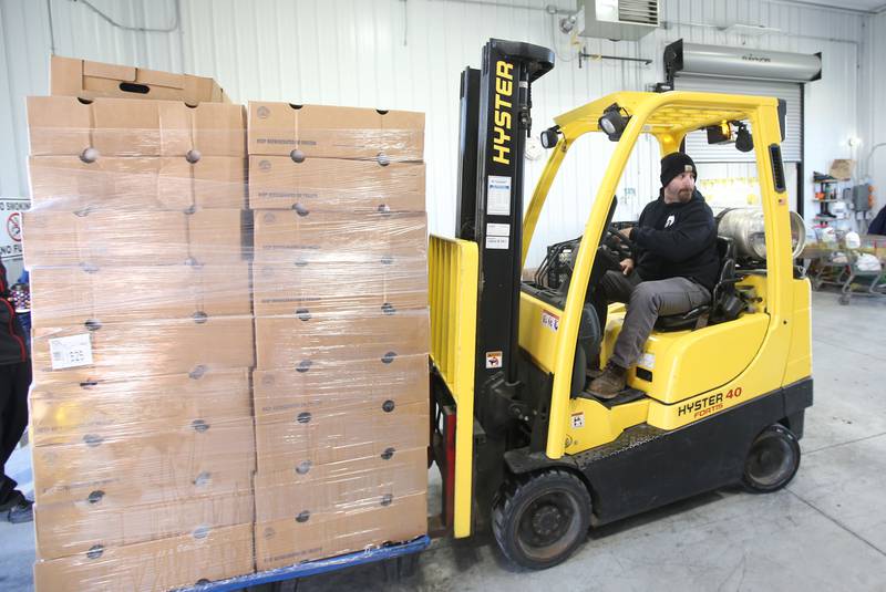 Jeremy Andees moves a large pallet of turkeys into the loading zone for the annual Thanksgiving distribution on Wednesday, Nov. 20, 2024 at the Hall Township Food Pantry in Spring Valley.