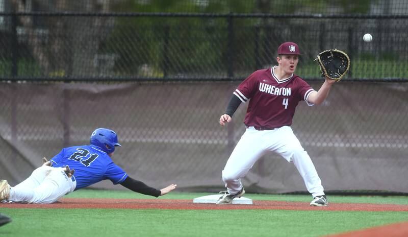 Wheaton Academy's Will Clegg (4) waits for the throw as St. Francis' Cole Danner slides safely back to first on a pickoff attempt during Tuesday’s baseball game in West Chicago.