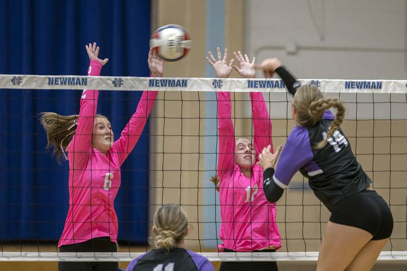Newman’s Kennedi Shippert (left) and Amaya Gomez go up to block a shot against Dixon’s Leah Carlson Thursday, Oct. 3, 2024, at Newman High School.
