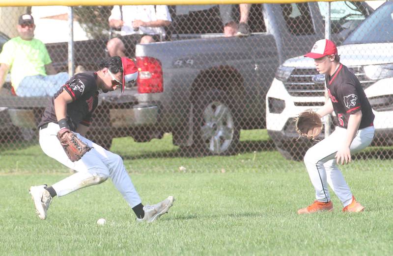 Erie-Prophetstown's Ethan Daubman and Dante Pels chase after a ball hit in right-center field against Hall on Monday, April 28, 2025 in Foley Field at Kirby Park in Spring Valley.