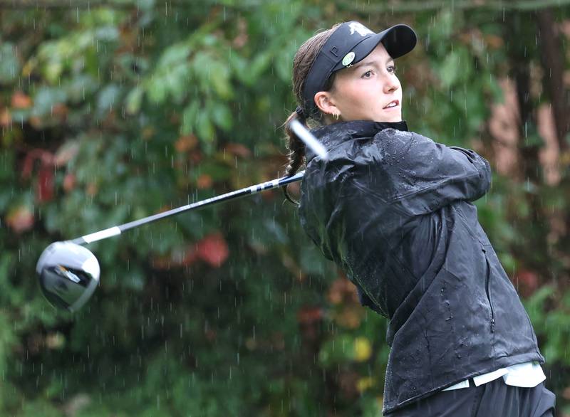 Kaneland’s Kailey Kunstman watches her drive off of the third tee Tuesday, Sept. 24, 2024, during the Interstate 8 girls golf tournament at the Sycamore Golf Club.
