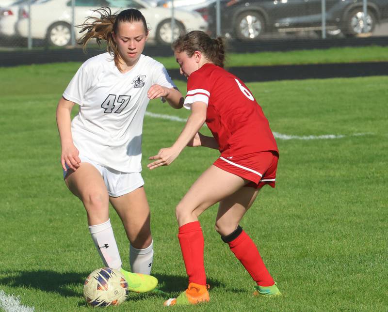 Kaneland's Audrey Noring gets the ball past Ottawa's Kindley Moore on Wednesday, April 22, 2026 on King Field at Ottawa High School.