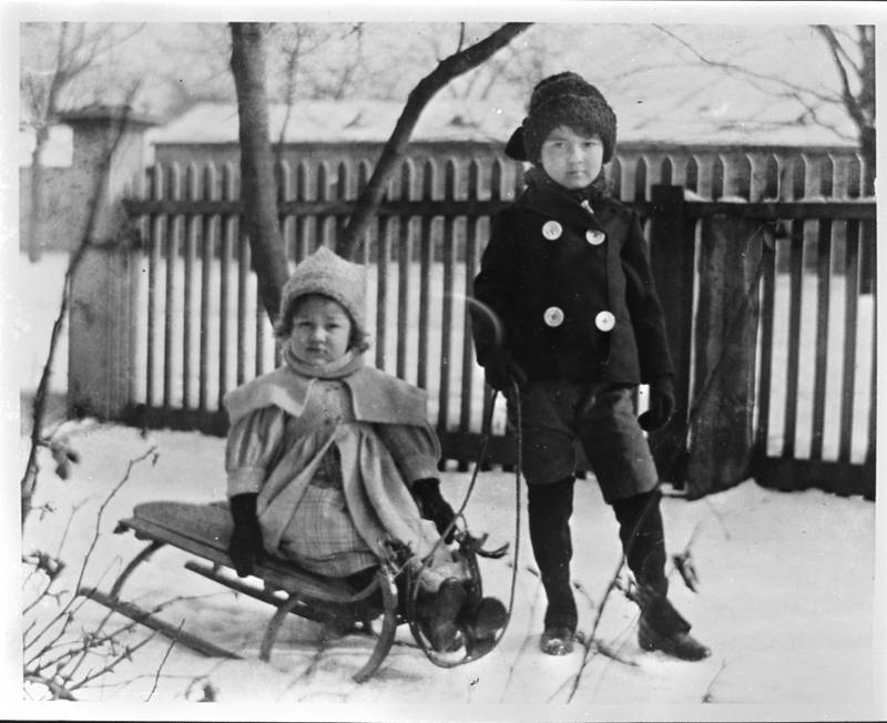 Two children take their sled outside for a bit of winter fun in 1903 in Joliet.