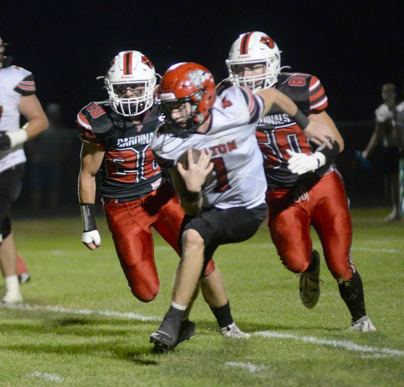 Fulton quarterback Braedon Meyers runs with the ball as Forreston's Liam Stetterstrom (20) and Austin Collis (60) give chase on Friday, Sept. 12, 2025 in a NUIC game in Forreston.