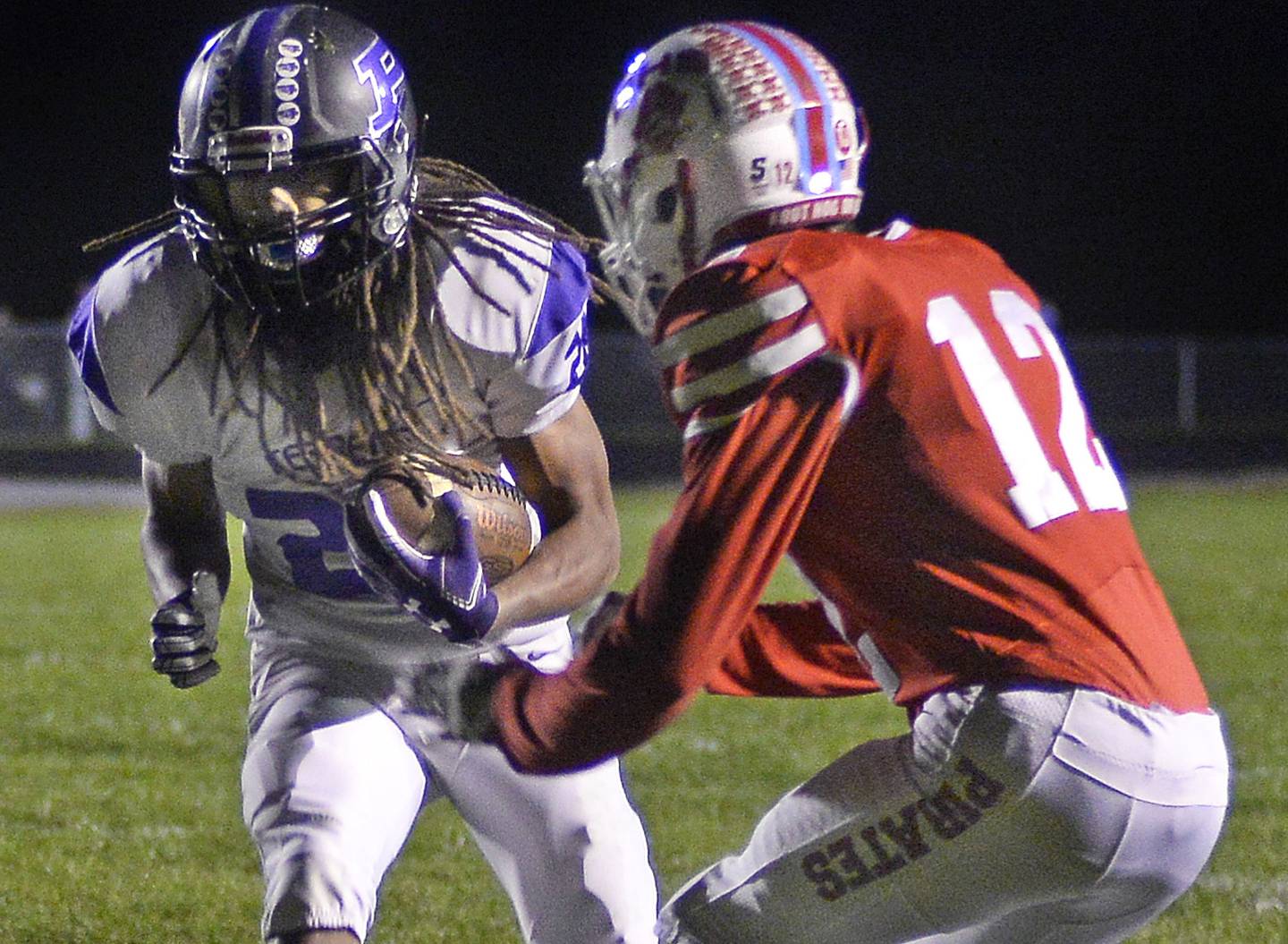 Ottawa’s Conner Price (12) tries to stop Plano’s Ray Jones Jr. near the goal line Friday, Oct. 22, 2021, at Ottawa's King Field.