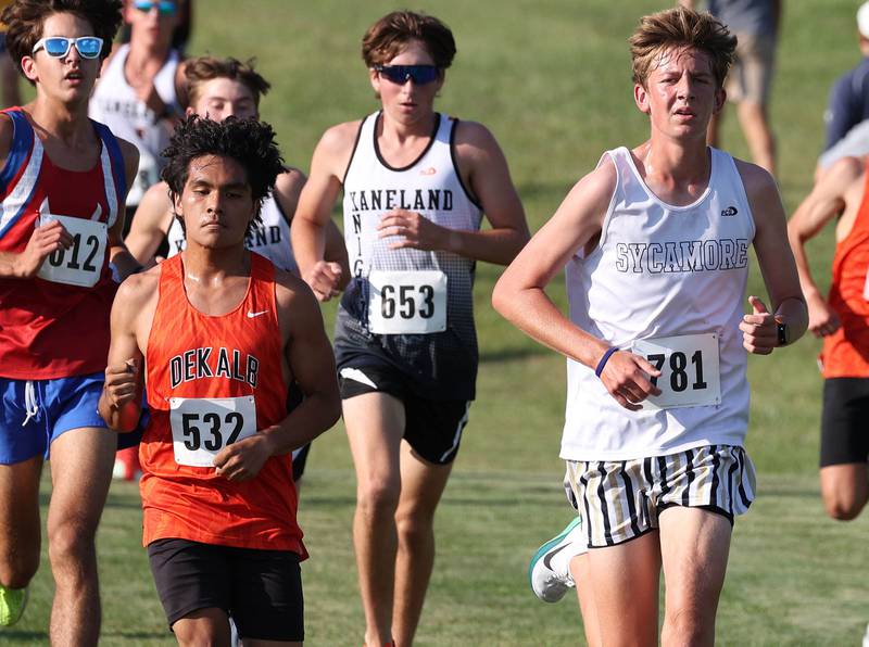 Dekalb’s Andy Duran, (left) Kaneland’s Gavin Schnurstein and Sycamore’s Liam Berry (right) run together in a pack Tuesday, Sept. 2, 2025, during the Sycamore Cross Country Invitational at Northern Illinois University in DeKalb.