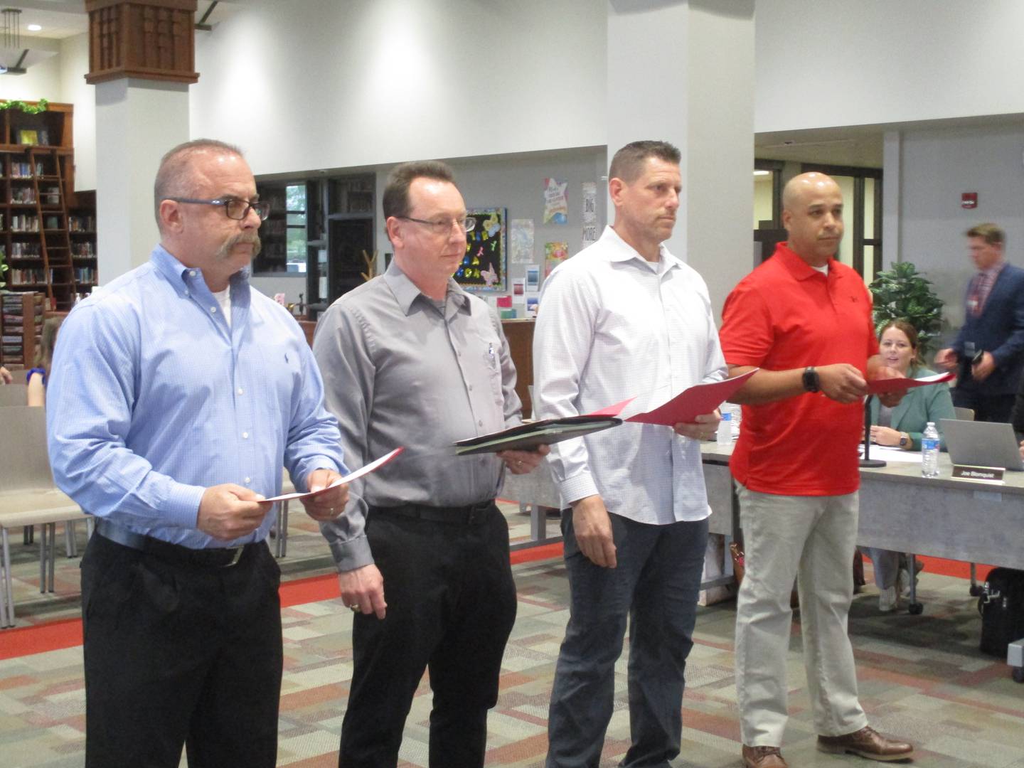 Four newly elected members of the Yorkville School District Y115 Board of Education prepare to take the oath of office on May 8, 2023 at the Yorkville High School library. They are, from left, Jason Demas, Darren Crawford, Michael Knoll and Michael Houston.