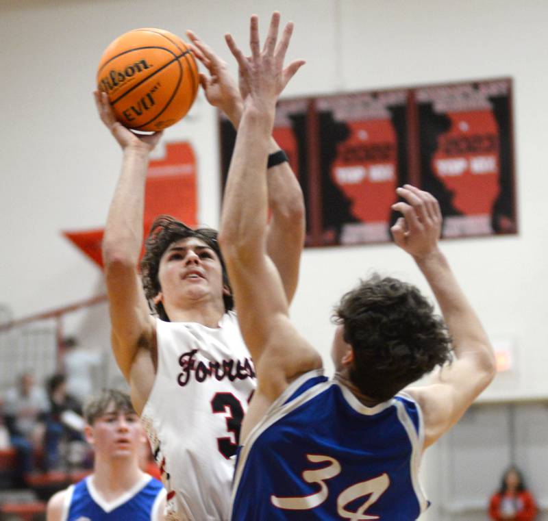 Forreston's Jonathan Milnes shoots over an Oregon defender during a Saturday, Jan. 25, 2025 game at Forreston High School.