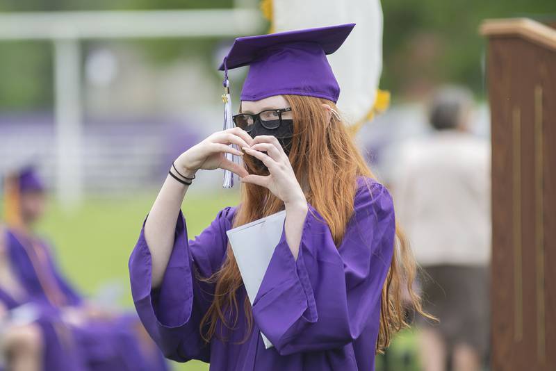 Lillian Deter gestures towards friends after receiving her diploma during Dixon’s High School’s graduation Sunday, May 29, 2022.