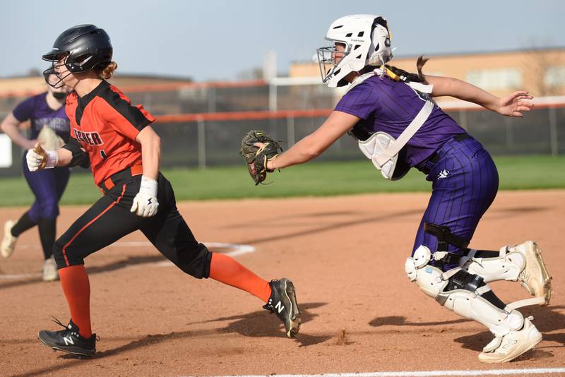 Beecher's Alexa Gliva, left, is chased back to third base by Wilmington catcher Madisyn Rossow during a game at Beecher Thursday, April 24, 2025.