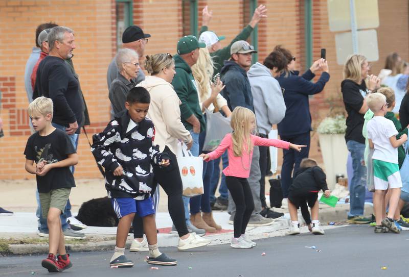 Kids pick up candy during the St. Bede Homecoming parade on Friday, Sept. 27, 2024 downtown Peru.