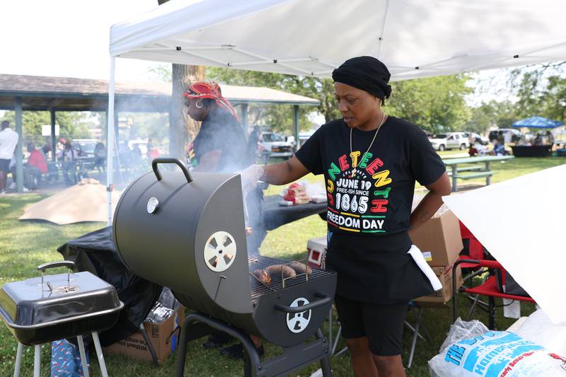 Renee Sanders, left, and Chaquita Taylor prepare food during the Juneteenth Freedom Festival at Pioneer Park on Saturday, June 21, 2025.