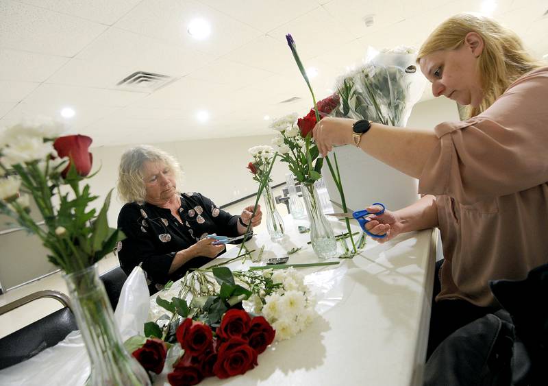 Auxiliary President Diane Dillow (left) and Treasurer Rachel McNanmee prepare flowers for Memorial Day during a smaller Fun Fest, due to Sunday morning's rain, on May 26, 2024, at the Yorkville American Legion Post 489.