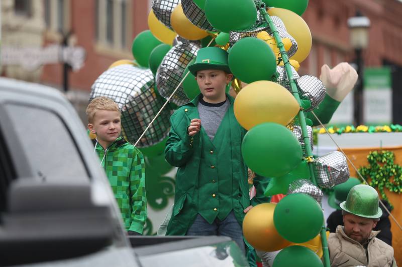 Kids wave to the crowds from Village Preservation Association of Plainfield float at the annual Plainfield Hometown Irish Parade on Sunday, March 15, 2026 in Plainfield.