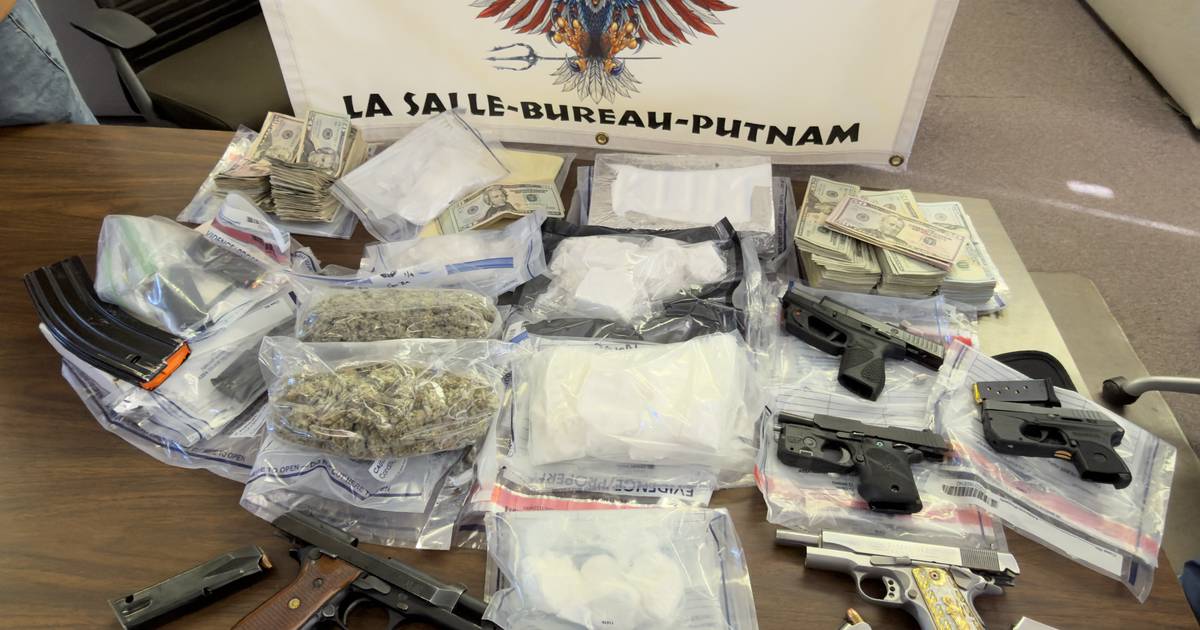 Two men await detention hearings after a Wednesday traffic stop in Peru yielded more than 2 ounces of cocaine -- and after a pair of search warrants yielded guns and another 4-plus pounds of cocaine.