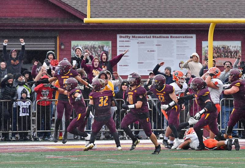 Montini fans and players start to celebrate after stopping Byron's 2-point conversion attempt to clinch a 14-13 win in a Class 3A second-round game on November 9, 2024 at Montini Catholic High School in Lombard.