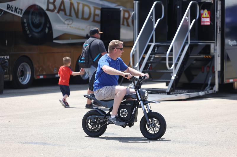 A race fan rides around the complete on a mini bike at the NHRA’s Gerber Collision and Glass Route 66 Nationals at Route 66 Raceway on Sunday, May 19, 2024 in Joliet.