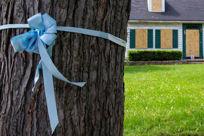 The house where Andrew “AJ” Freund was allegedly killed by his parents, JoAnn Cunningham and Andrew Freund Sr., sits boarded up Wednesday in Crystal Lake.