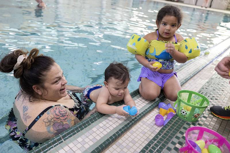 Koreen Terrock with kids Zeppelin Terrock, 1, and Zella Glenn, 3, check out their gathered eggs Friday, April 11, 2025, at the YMCA Egg Hunt in Sterling.