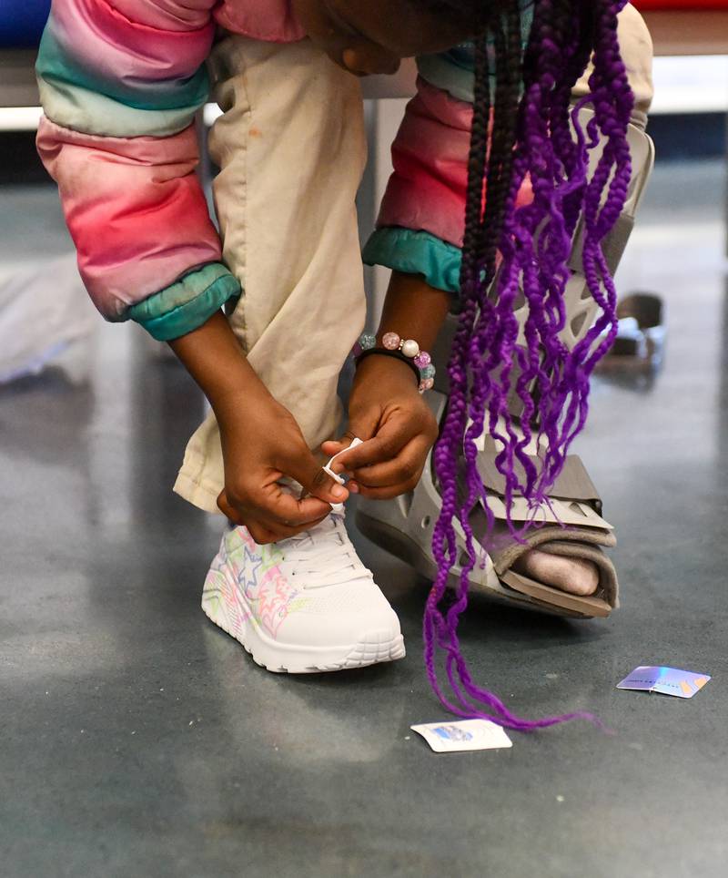 A Steuben Elementary student puts on her new pair of shoes as part of the Kankakee Kiwanis Club's annual “All God’s Children Must Have Shoes” event on Feb. 27, 2025, at Shoe Carnival.