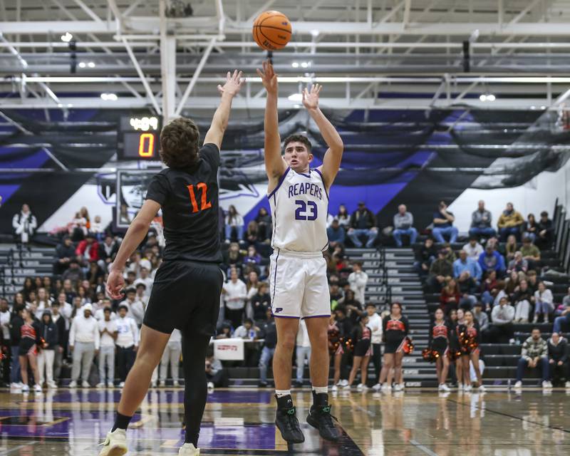 Plano's Cooper Beaty (23) shoots a jumper from the top fo the key during their basketball game between Sandwich at Plano Tuesday, Dec 9, 2025 in Plano.