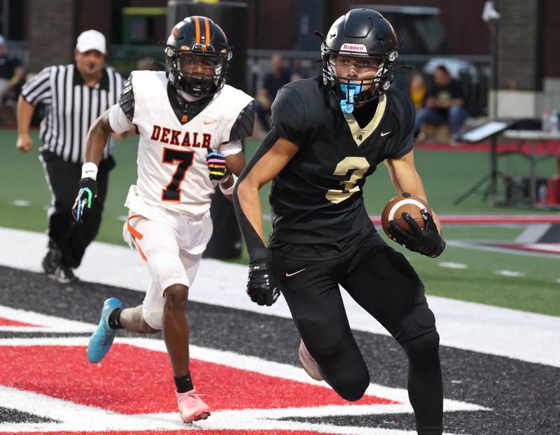 Sycamore punter Benjamin Anderson tries to get the ball out of the endzone after a bad snap with DeKalb's Antwaun Thomas in pursuit Friday, Aug. 29, 2025, during the FNBO Challenge in Huskie Stadium at Northern Illinois University.