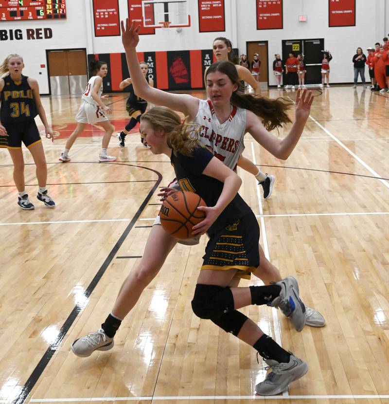 Polo's Camrynn Jones (front) drives the baseline while being guarded by Amboy's Courtney Ortgiesen during the Class 1A Amboy Regional final Friday night.