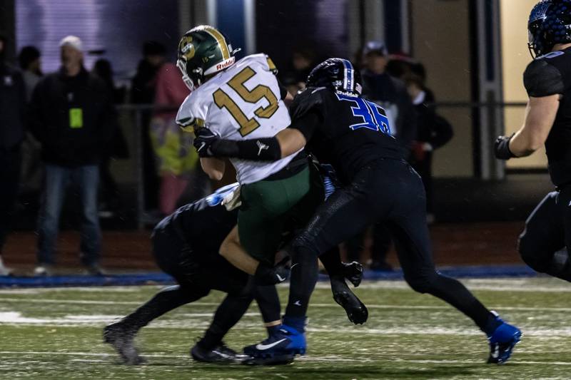 Lincoln-Way East's Colton Zvonar tackles Stevenson's Aidan Crawley during a varsity football round one playoff game at Lincoln-Way East on Oct. 31, 2025.
