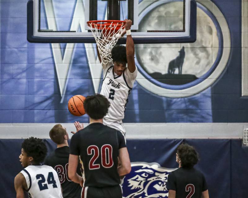 Oswego East's Jacsen Tucker (2) dunks during their basketball game between Plainfield North at Oswego East Friday, Dec 5, 2025 in Oswego.