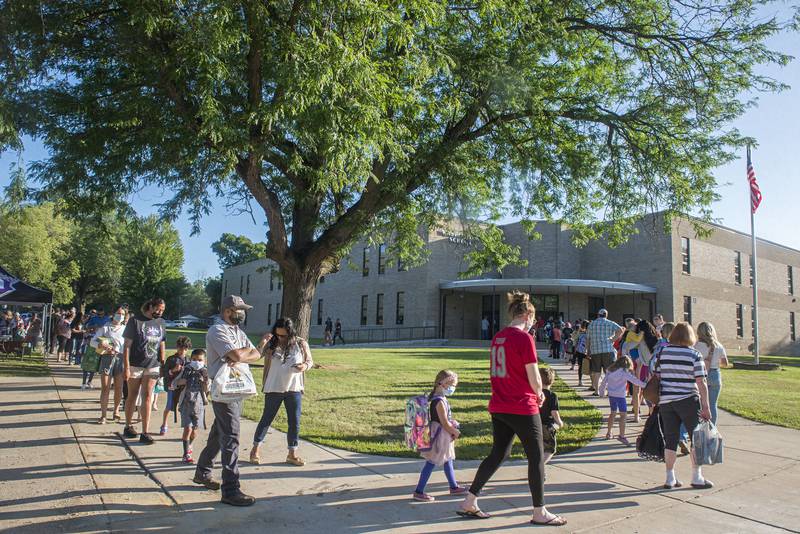 In a file photo from Aug. 16, 2021, parents and students line up down the sidewalk outside of Washington School in Dixon. A more stable school population is one of the possible outcomes from the two tax increment financing districts the city of Dixon is nearing approval on, City Manager Danny Langloss said in a presentation at Dixon Public Schools board of education meeting in March.