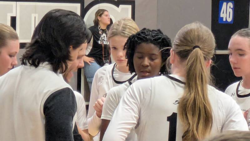 Kaneland sophomore Amani Meeks (center) listens during a huddle in overtime of the Knights' 55-49 win against Sycamore on Friday, Dec. 13, 2024.