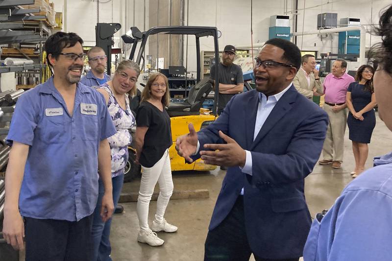 Republican candidate for Illinois governor Richard Irvin speaks with employees during a tour of HM Manufacturing Inc. in Wauconda, Ill., June 21, 2022. Irvin is seeking the Republican nomination to face Democratic Gov. J.B. Pritzker in November. (AP Photo/Sara Burnett)