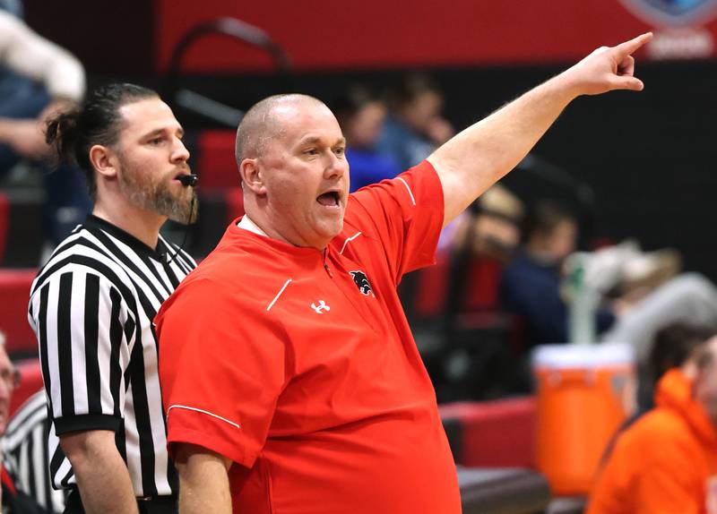 Indian Creek head basketball coach Paul Muchmore talks to his team Monday, Dec. 8, 2025, during their game against Genoa-Kingston at Indian Creek High School in Shabbona.