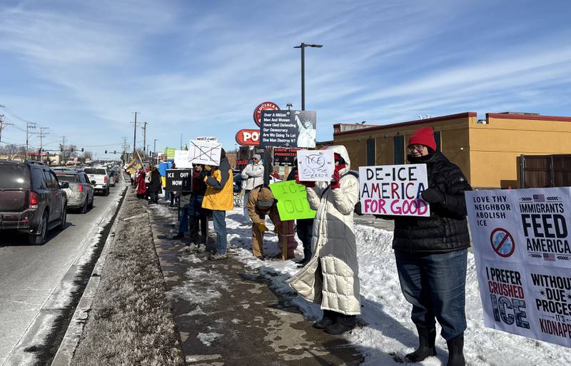 Protesters hold signs against ICE at a protest in McHenry Feb. 1, 2026.