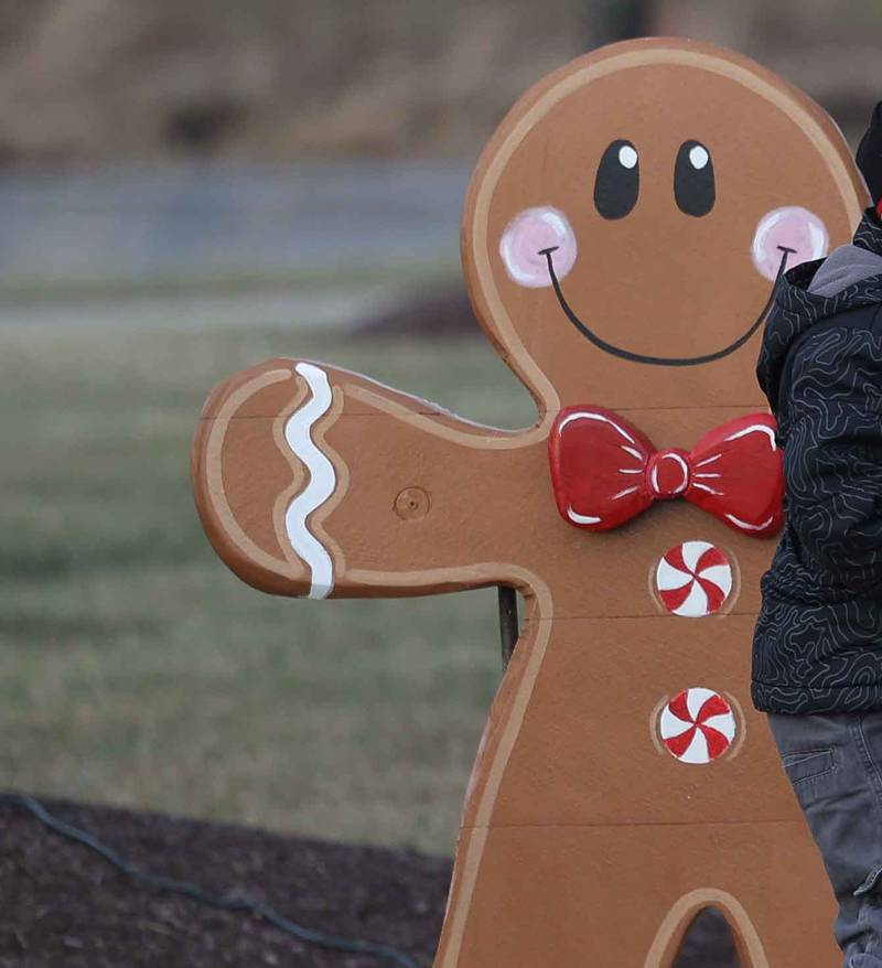 Mickey and Alec O’Brien play at a gingerbread house at the Shorewood Holiday Market on Saturday, Dec. 7, 2024.