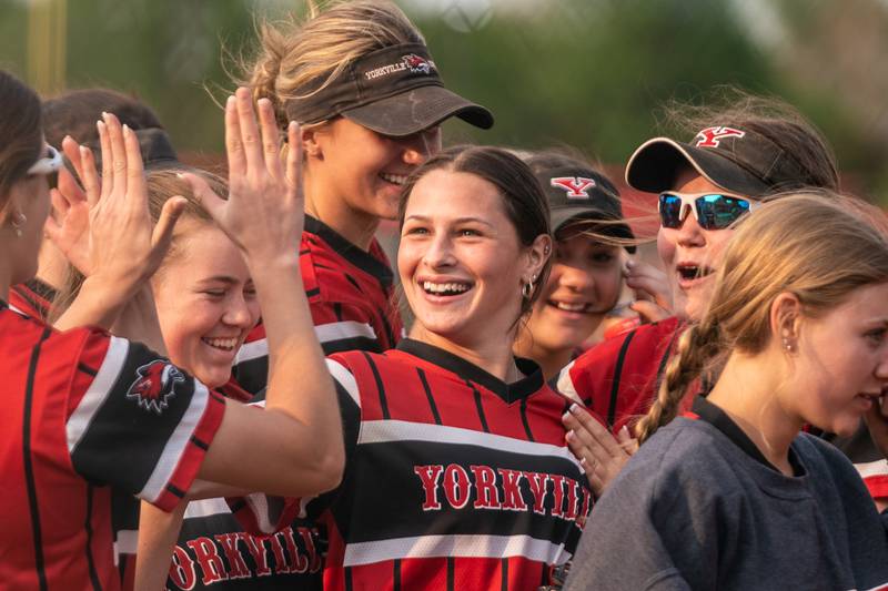 Yorkville's Julia Hupp (center) smiles as she is greeted by her team after pitching a complete-game shutout against Oswego at Yorkville High School on Wednesday, May 17, 2023.
