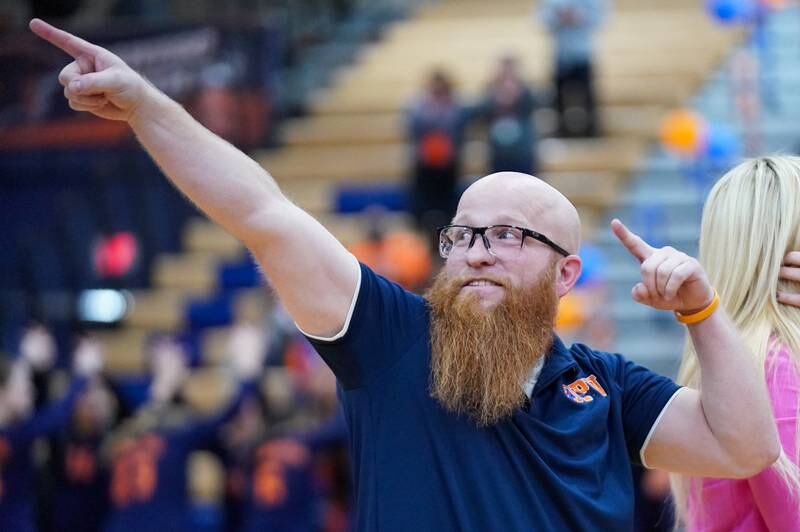 Oswego head coach Chase Mang points to the Oswego student section after defeating Joliet West during a volleyball match at Oswego High School on Thursday, October 24, 2024.