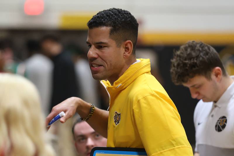 Joliet West head coach Jeremy Kreiger talks to the players during a timeout against Plainfield East on Friday, Dec. 19, 2025 in Joliet.