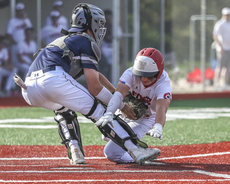 Yorkville's Justin Giese (8) is tagged out at the plate during baseball game between Oswego East at Yorkville. Monday, May 12, 2025 in Yorkville.