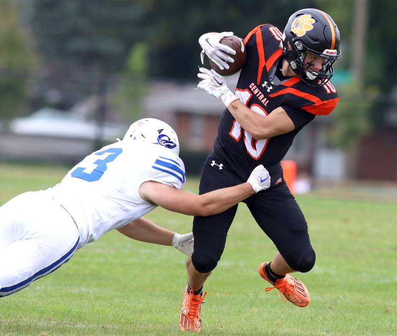 right, escapes Burlington Central’s Tyler Eshoo in varsity football at Crystal Lake Saturday.