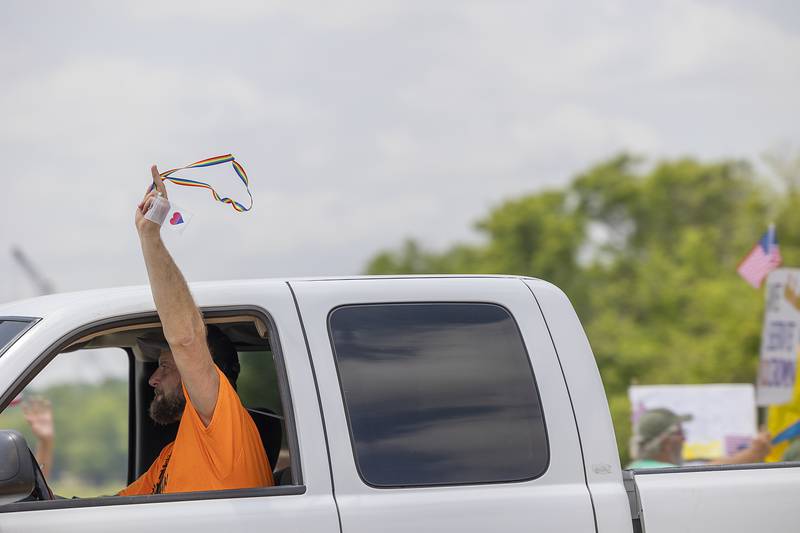 Passersby wave in solidarity to protesters in Dixon during a nationwide No Kings protest Saturday, June 14, 2025. The anti-Trump gathering lined both sides of the Peoria Avenue Bridge.