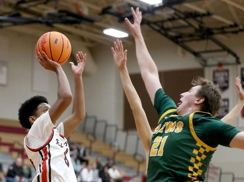 Huntley's Isaac Muze shoots the ball over Crystal Lake South's Ryan Morgan during a Fox Valley Conference boys basketball game on Wednesday, Dec. 10, 2025, at Huntley High School.
