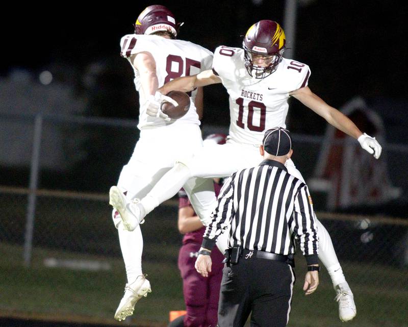 Richmond-Burton’s Max Loveall (10) celebrates with teammate Lukas Bresnahan (85) after a touchdown in varsity football at Rod Poppe Field in Marengo Thursday night.